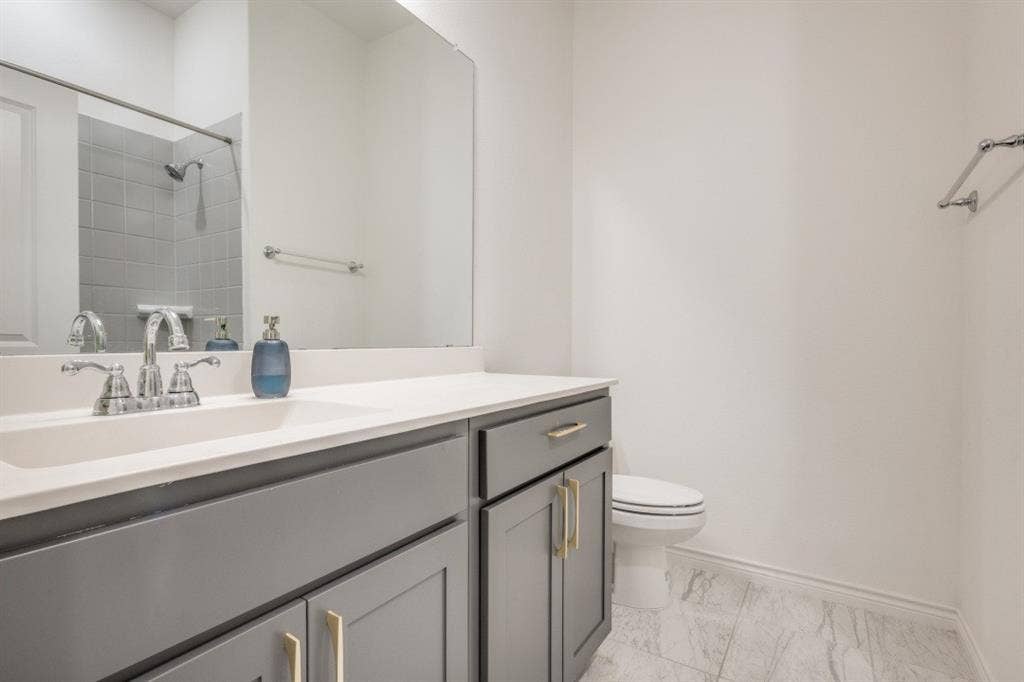 2813 Walker Way, Northlake, TX 76247 Bathroom featuring a vanity with gray cabinetry, a white countertop, and an integrated sink with a chrome faucet