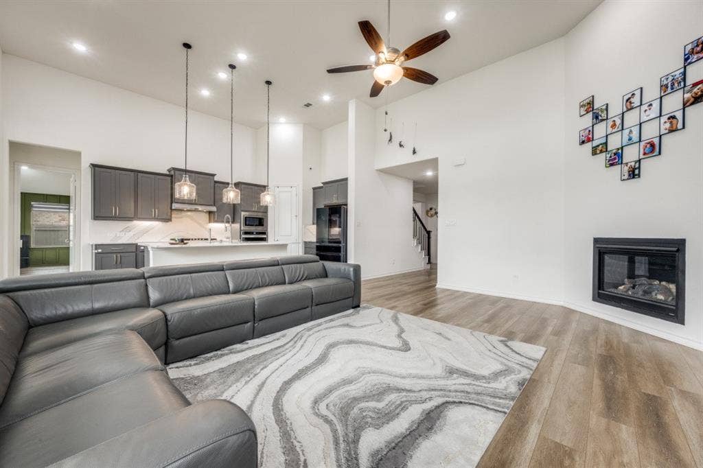 2813 Walker Way, Northlake, TX 76247 Open concept living space featuring wood-finish flooring, a contemporary fireplace, and high ceilings