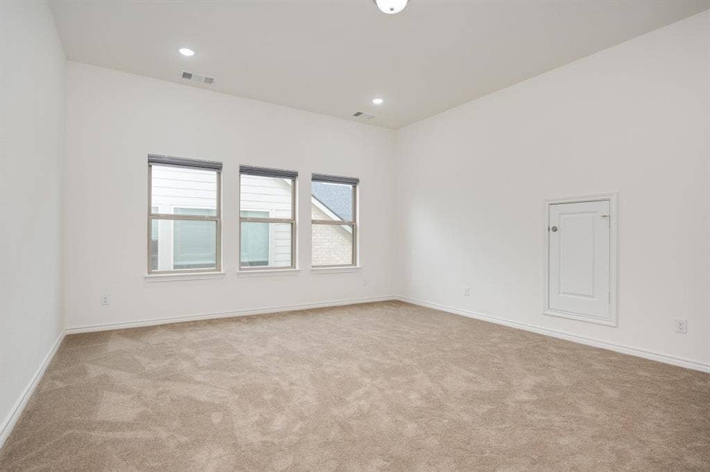 2813 Walker Way, Northlake, TX 76247 Spacious room featuring three windows, neutral-toned carpet, white walls, and a ceiling with recessed lighting and a flush-mount fixture