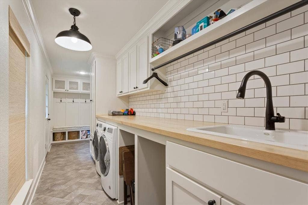402 Shadow Mountain Drive, Woodway, TX 76712 Utility room featuring white shaker cabinetry, an undermount sink with a matte black faucet, wood-finish countertops, and a white subway tile backsplash