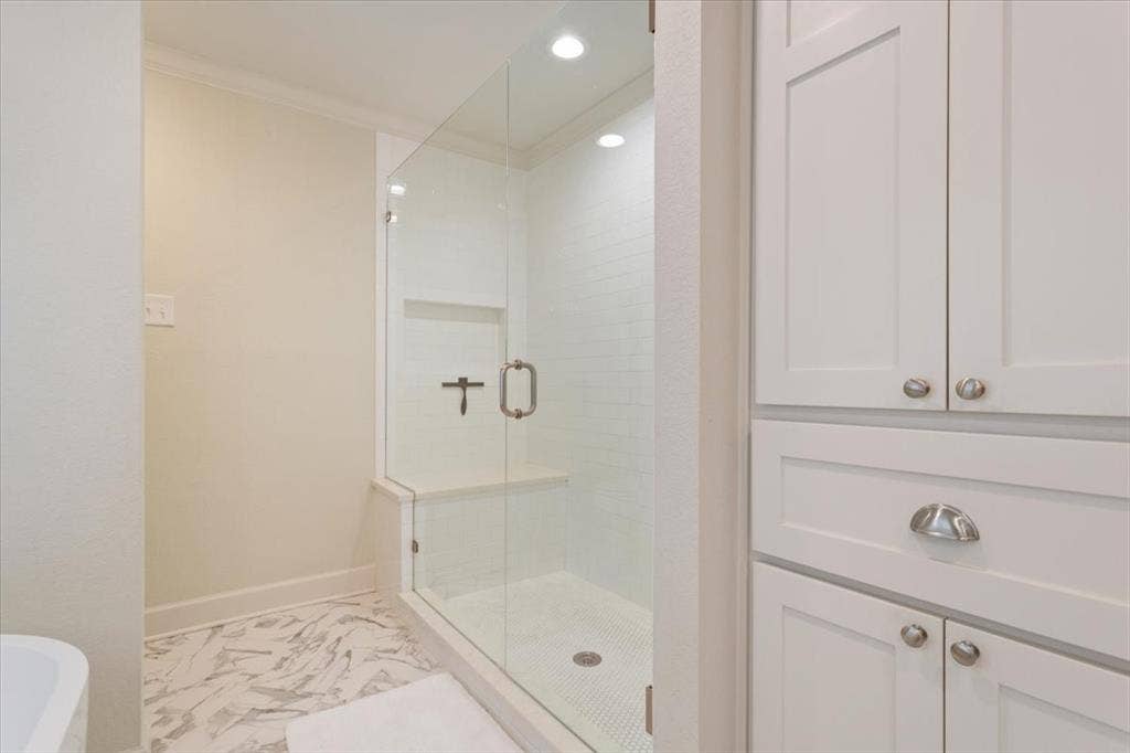 402 Shadow Mountain Drive, Woodway, TX 76712 Upstairs glass-enclosed shower with a built-in bench and recessed shelving