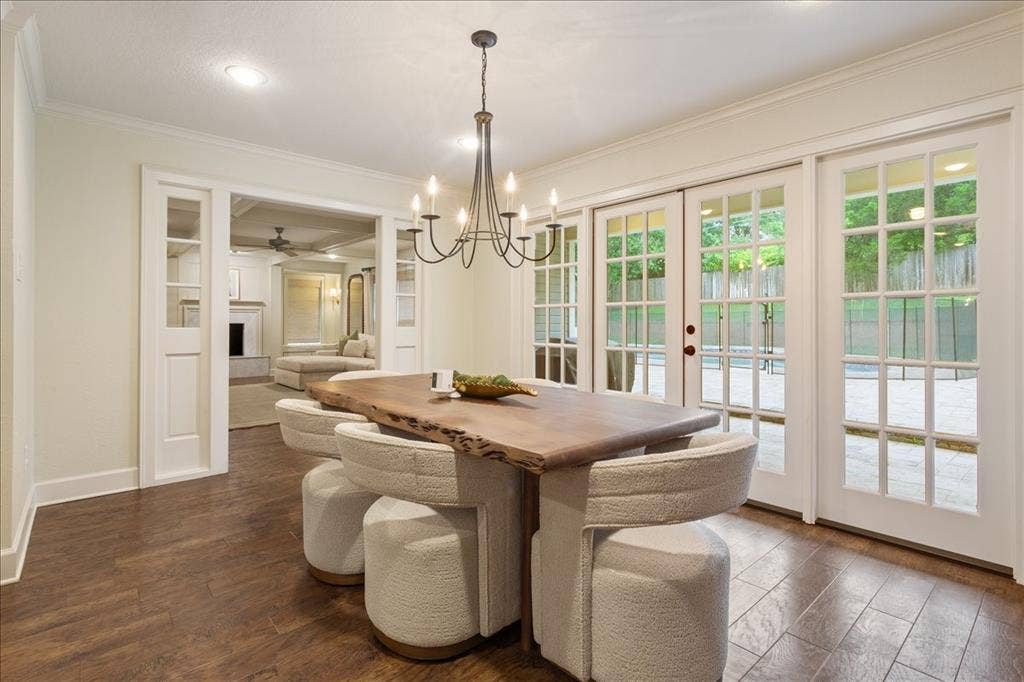402 Shadow Mountain Drive, Woodway, TX 76712 Dining area featuring wood-finish flooring and a contemporary chandelier