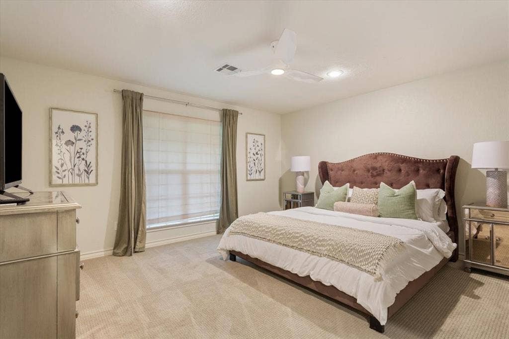 402 Shadow Mountain Drive, Woodway, TX 76712 Upstairs carpeted bedroom with a large window featuring blinds and drapes, a ceiling fan with integrated lighting, and recessed ceiling lights