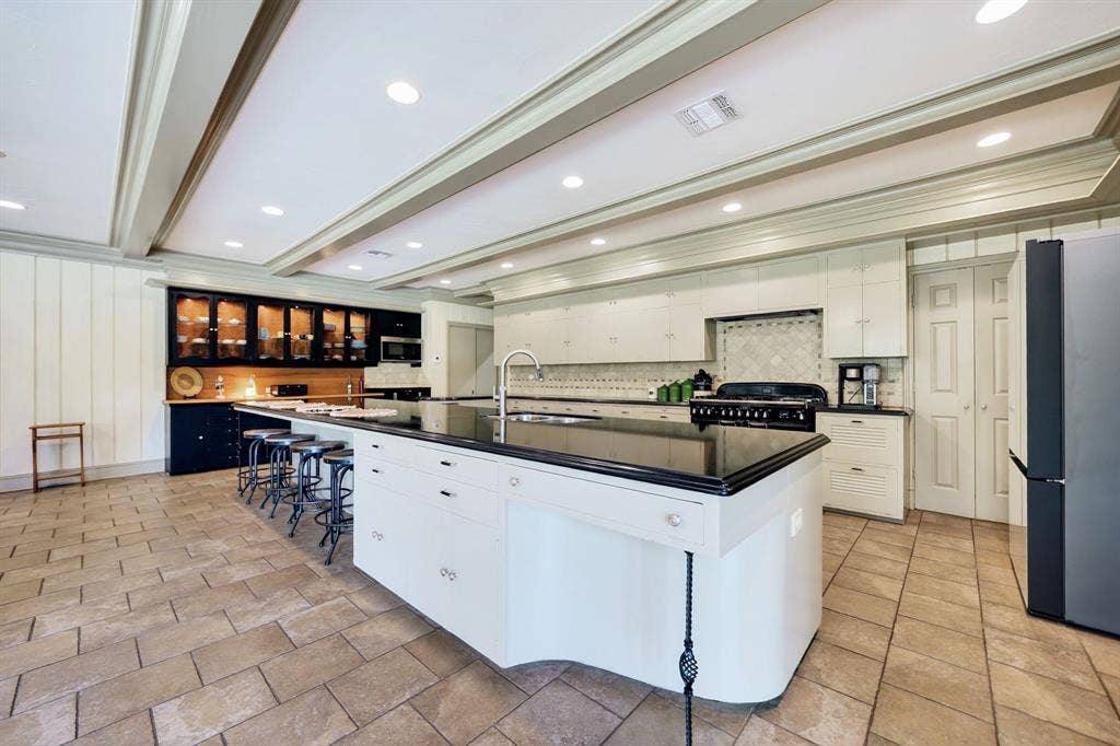 1901 Rose Point, Athens, TX 75752 Spacious kitchen featuring a large central island with a sink and seating, white cabinetry, integrated range, tile flooring, and coffered ceilings with recessed lighting