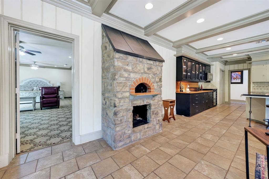 1901 Rose Point, Athens, TX 75752 Stone-clad pizza oven with an arched brick opening