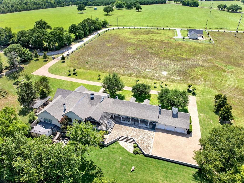 1901 Rose Point, Athens, TX 75752 Expansive property featuring a large residence with a multi-car garage, extensive paved and stone driveways, and mature landscaping