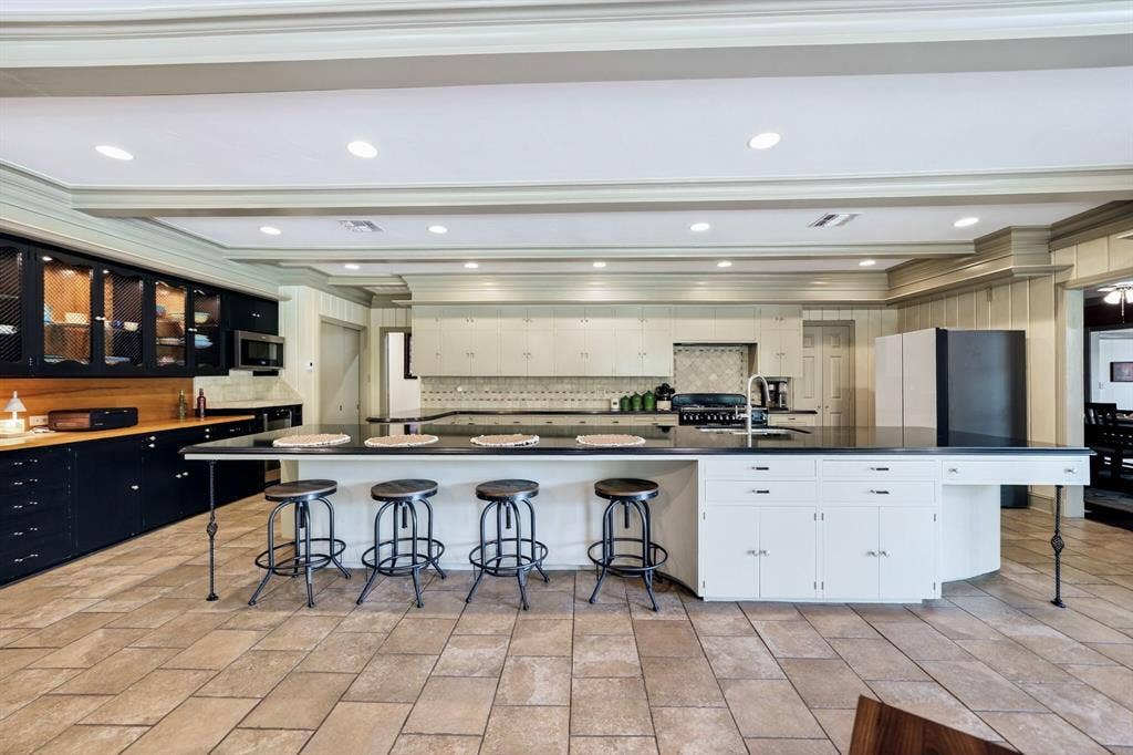 1901 Rose Point, Athens, TX 75752 Kitchen featuring a large central island with seating, dark countertops, built-in cabinetry, recessed lighting, and tile flooring