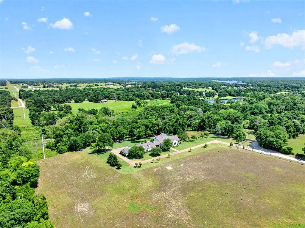 1901 Rose Point, Athens, TX 75752 Expansive parcel featuring a single-story residence with a gray shingle roof, surrounded by mature trees and open fields