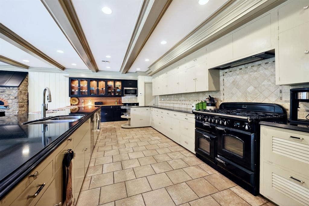 1901 Rose Point, Athens, TX 75752 Spacious kitchen featuring a large black range, extensive cabinetry, recessed lighting, and a stone pizza oven