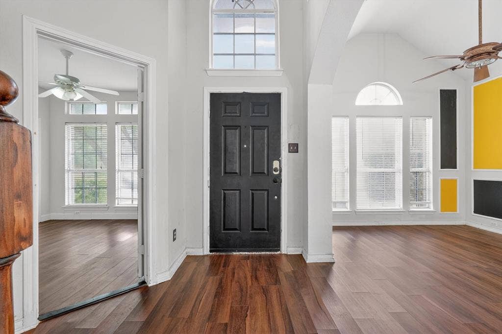 Entryway featuring a black paneled door with an arched transom window
