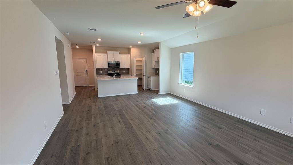 3013 Hidden Valley Drive, Lindale, TX 75771 Open-concept living area featuring wood-finish flooring, recessed lighting, and a ceiling fan