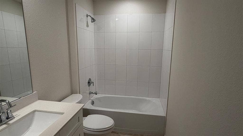 3013 Hidden Valley Drive, Lindale, TX 75771 Full bathroom featuring a white porcelain tub and shower combination with white tile surround