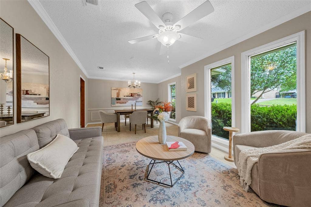 3301 Loma Vista Drive, Waco, TX 76708 Living area featuring crown molding, overhead ceiling fan with lighting, and multiple large windows