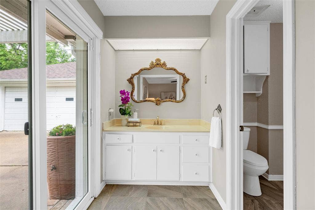 3301 Loma Vista Drive, Waco, TX 76708 White vanity with gold-tone hardware and a light-colored countertop