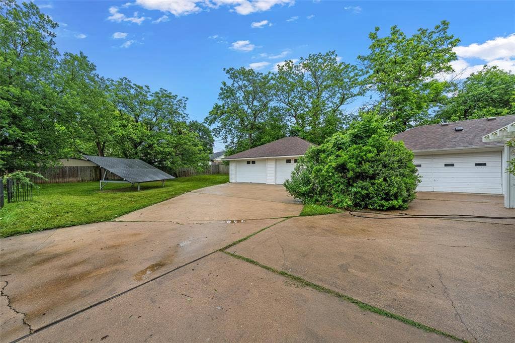 3301 Loma Vista Drive, Waco, TX 76708 Concrete driveway leading to multiple garage doors