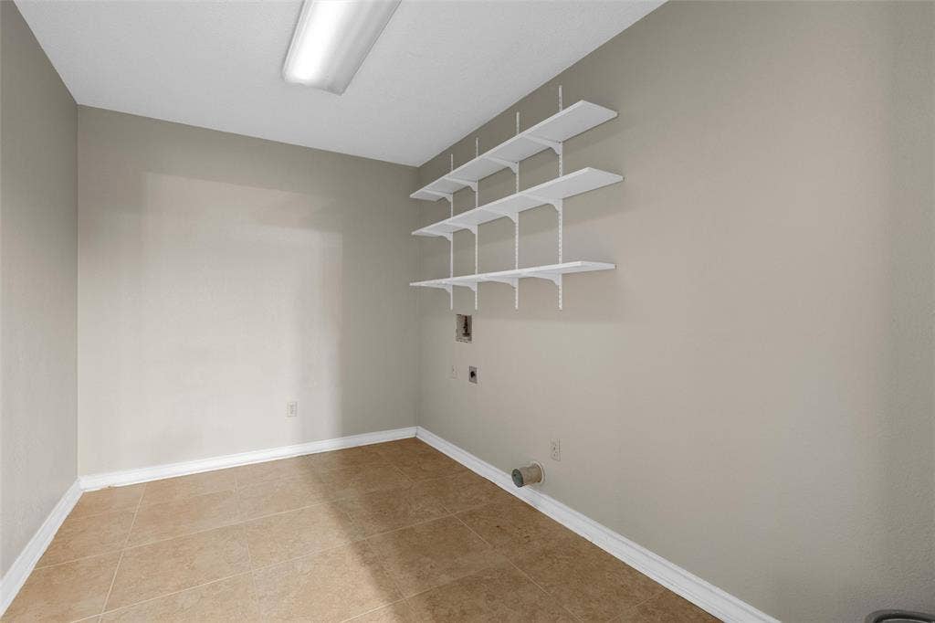 3301 Loma Vista Drive, Waco, TX 76708 Utility space with neutral-toned walls and ceramic tile flooring