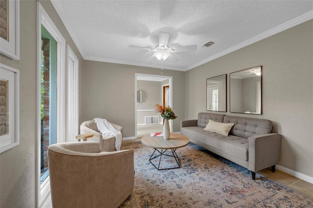 3301 Loma Vista Drive, Waco, TX 76708 Living area with neutral wall tones and crown molding
