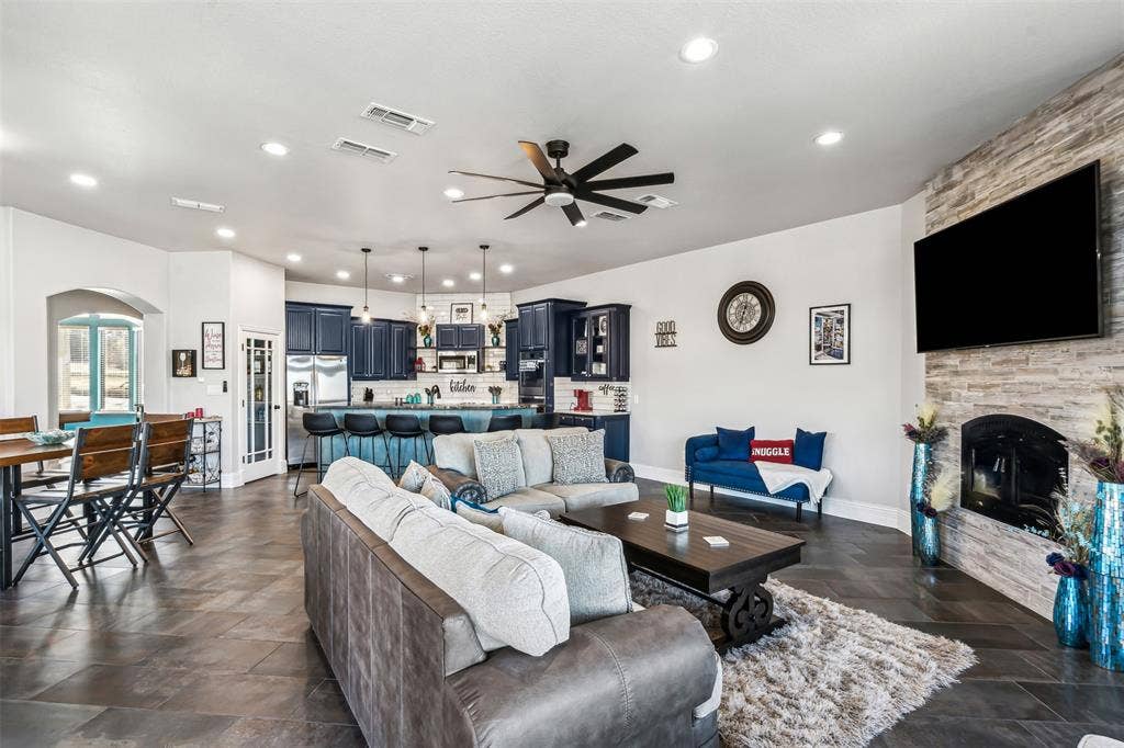 2100 Gene Court, Granbury, TX 76048 Open-concept living space featuring expansive tile flooring and recessed lighting