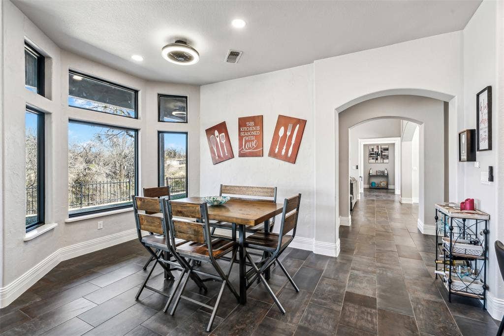 2100 Gene Court, Granbury, TX 76048 Dining area featuring dark wood-finish flooring and a bay window with multiple panes
