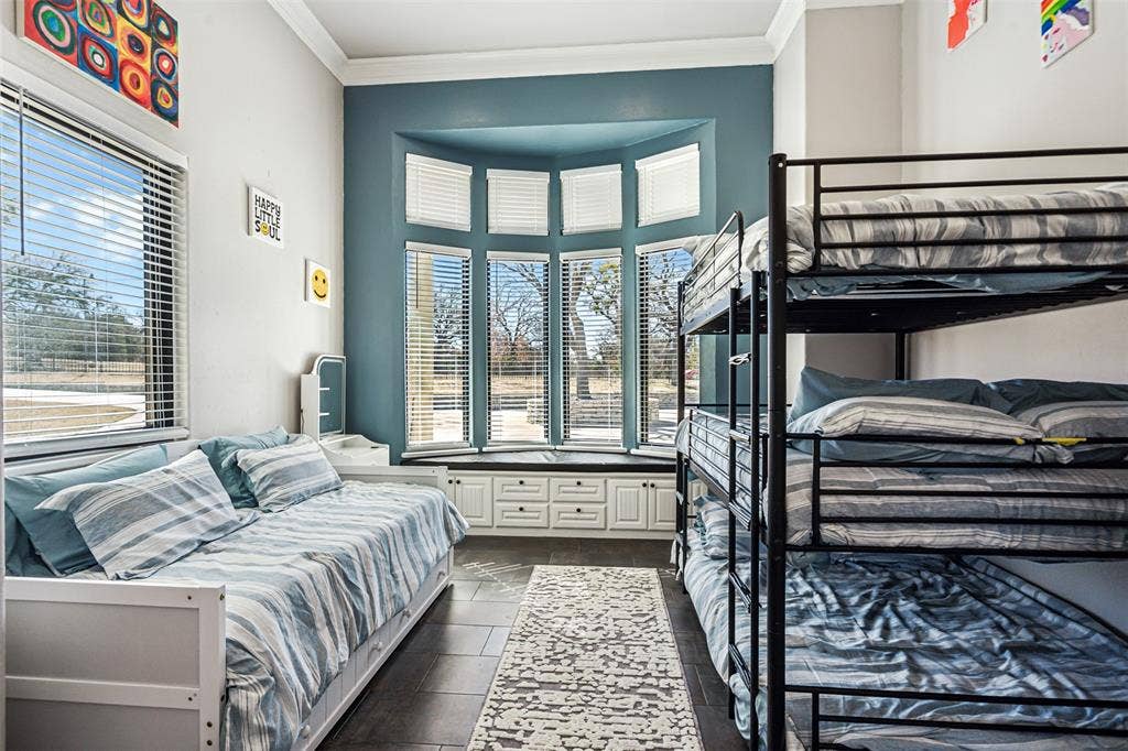 2100 Gene Court, Granbury, TX 76048 Room featuring a bay window with a built-in window seat and storage cabinetry
