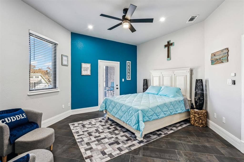 2100 Gene Court, Granbury, TX 76048 Room featuring dark tile flooring, a vibrant accent wall, a ceiling fan with integrated lighting, recessed lighting, and a private exterior door