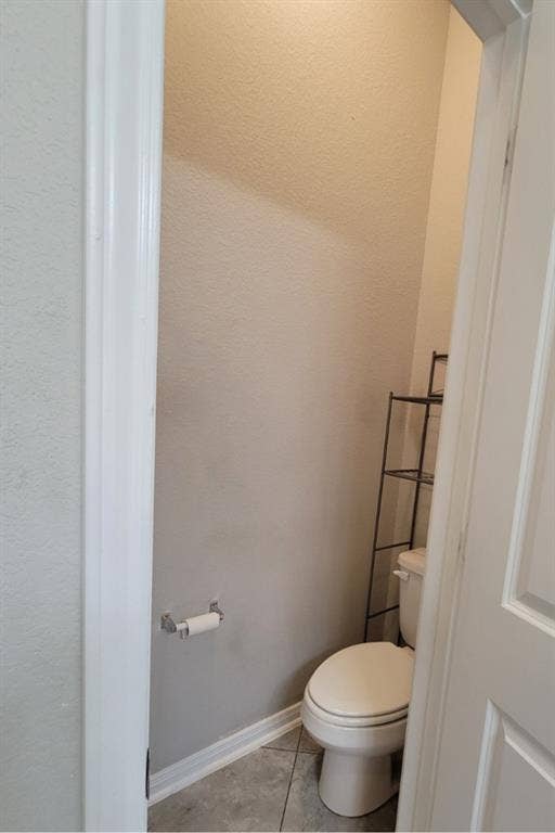 1106 Placid Circle, Waco, TX 76706 Powder room featuring a standard toilet, tiled flooring, and a wall-mounted toilet paper holder