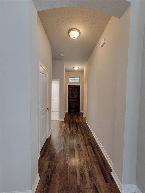 1106 Placid Circle, Waco, TX 76706 Entry corridor featuring wood-finish flooring, white baseboards, and neutral wall tones