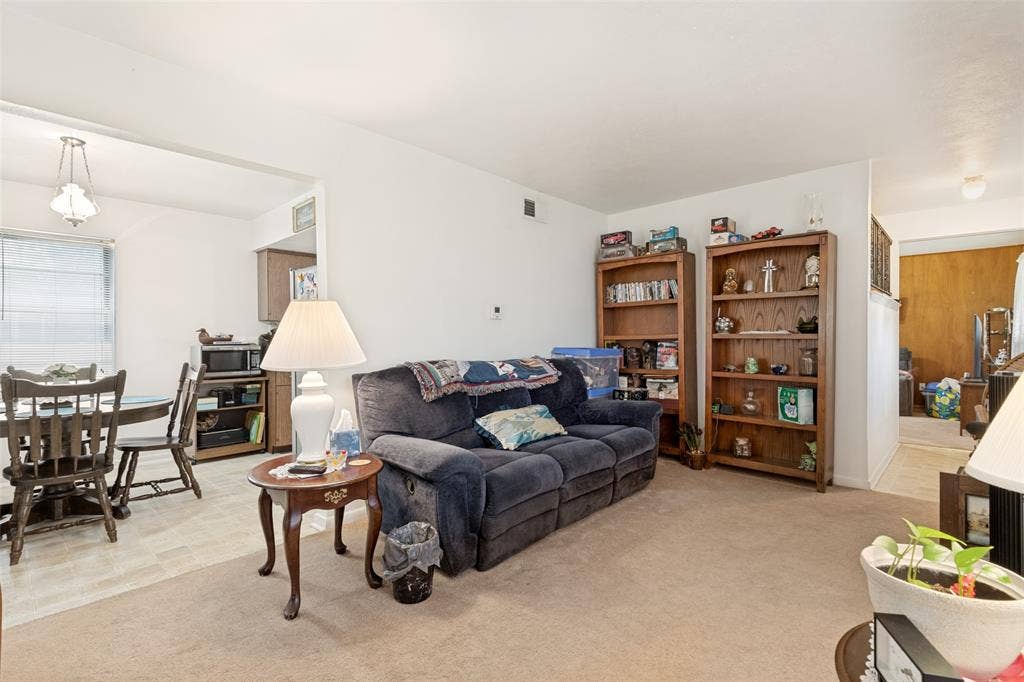 3013 Margo Drive, Mesquite, TX 75150 Carpeted living area with white walls and overhead lighting