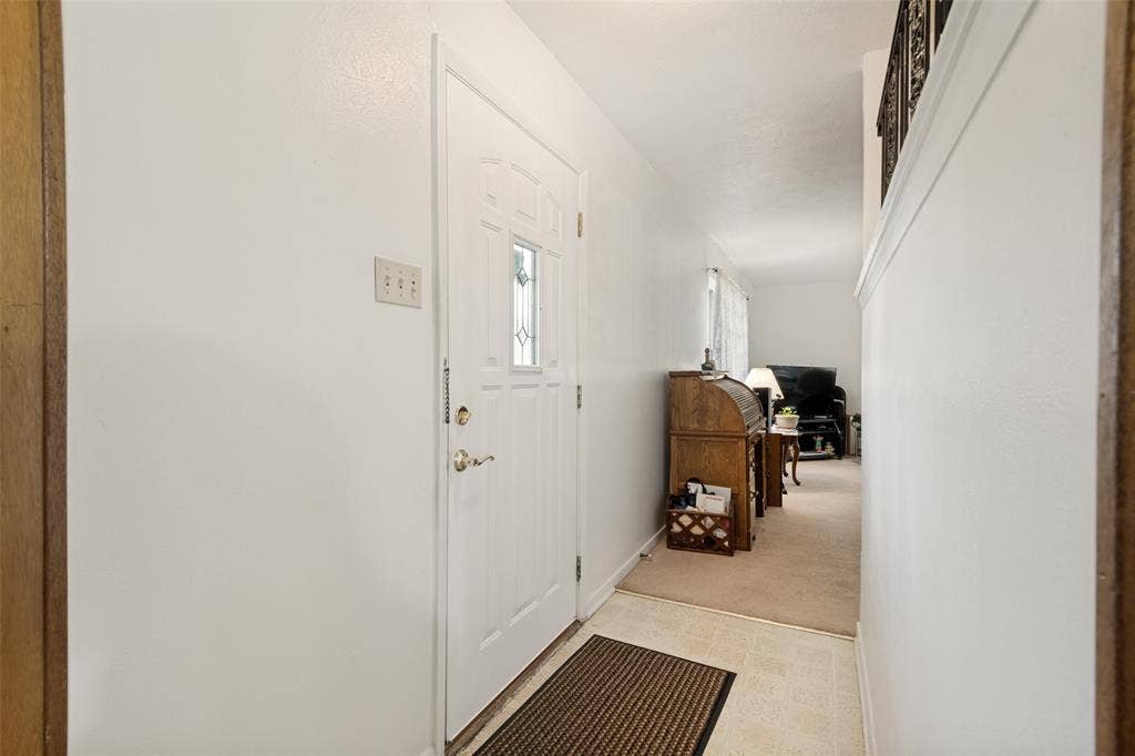 3013 Margo Drive, Mesquite, TX 75150 Entryway with a paneled white door featuring a decorative glass insert and brass hardware