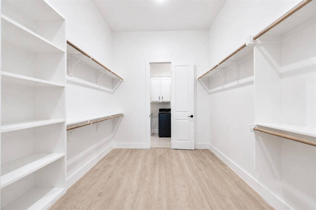 11965 Brubaker Drive, Frisco, TX 75033 Spacious walk-in closet featuring light wood-finish flooring, white walls, and recessed lighting