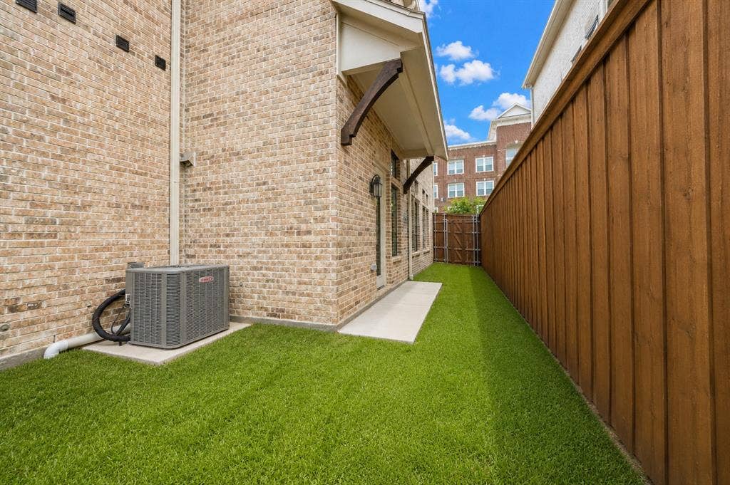 11965 Brubaker Drive, Frisco, TX 75033 Private outdoor space featuring artificial turf, a wood privacy fence, and a concrete patio