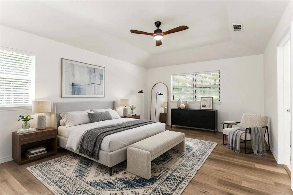 101 Hollyhill Lane, Denton, TX 76205 Spacious room featuring vaulted ceilings, wood-finish flooring, and white walls