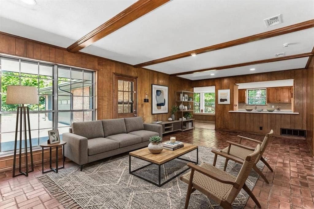 101 Hollyhill Lane, Denton, TX 76205 Living area featuring extensive wood paneling, exposed ceiling beams, and brick paver flooring