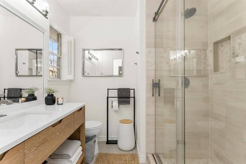 101 Hollyhill Lane, Denton, TX 76205 Modern bathroom featuring a glass-enclosed shower with tile surround and rain showerhead