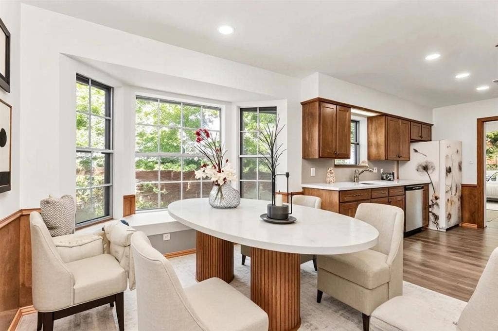 101 Hollyhill Lane, Denton, TX 76205 Bay window with integrated window seat, wood-finish flooring, recessed lighting, wood cabinetry, and solid surface countertops