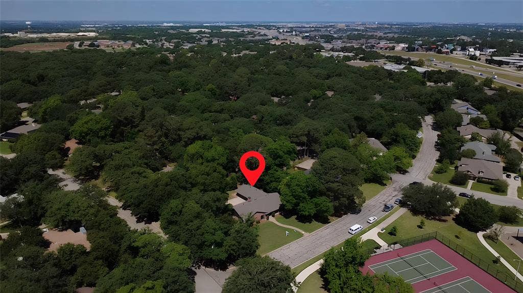 101 Hollyhill Lane, Denton, TX 76205 Residential property situated within a lush, tree-filled neighborhood