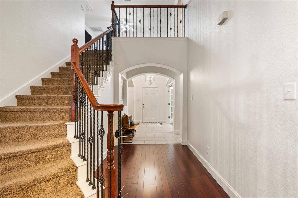 308 Bradbury Drive, Euless, TX 76040 Dramatic two-story entry with soaring ceilings, elegant staircase & rich hardwood flooring!