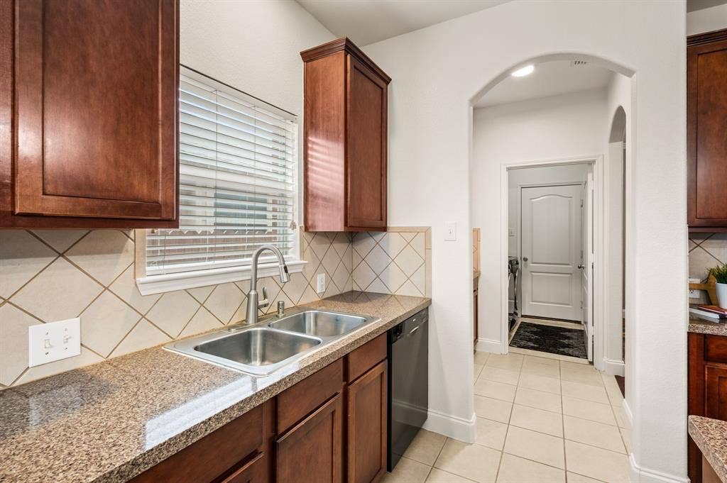 308 Bradbury Drive, Euless, TX 76040 Spacious kitchen with abundant counter space, rich cabinetry & convenient double sink layout.