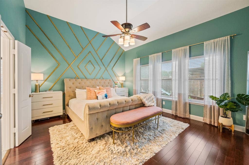 308 Bradbury Drive, Euless, TX 76040 Stunning primary suite with soaring ceilings, designer accent wall & beautiful hardwood flooring.