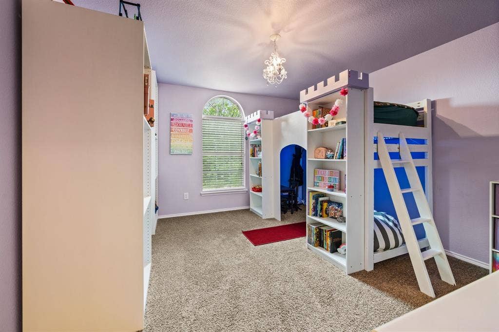 308 Bradbury Drive, Euless, TX 76040 Charming secondary bedroom with large window, whimsical light fixture, & plenty of space to play.