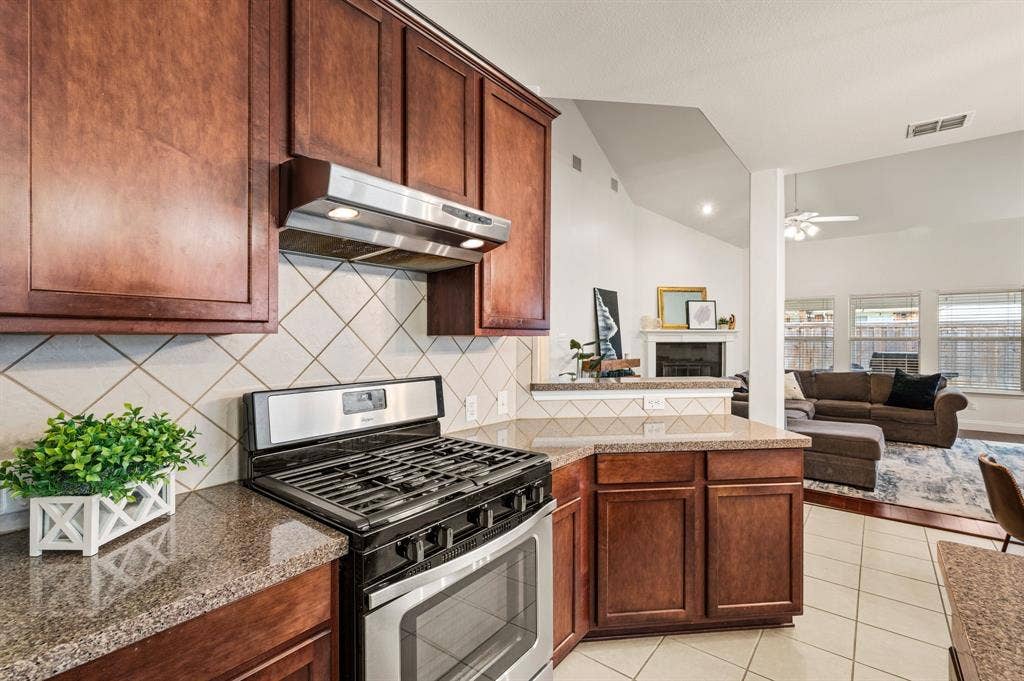 308 Bradbury Drive, Euless, TX 76040 Gas range, extensive counter space & open sightlines make this kitchen a dream for entertaining.