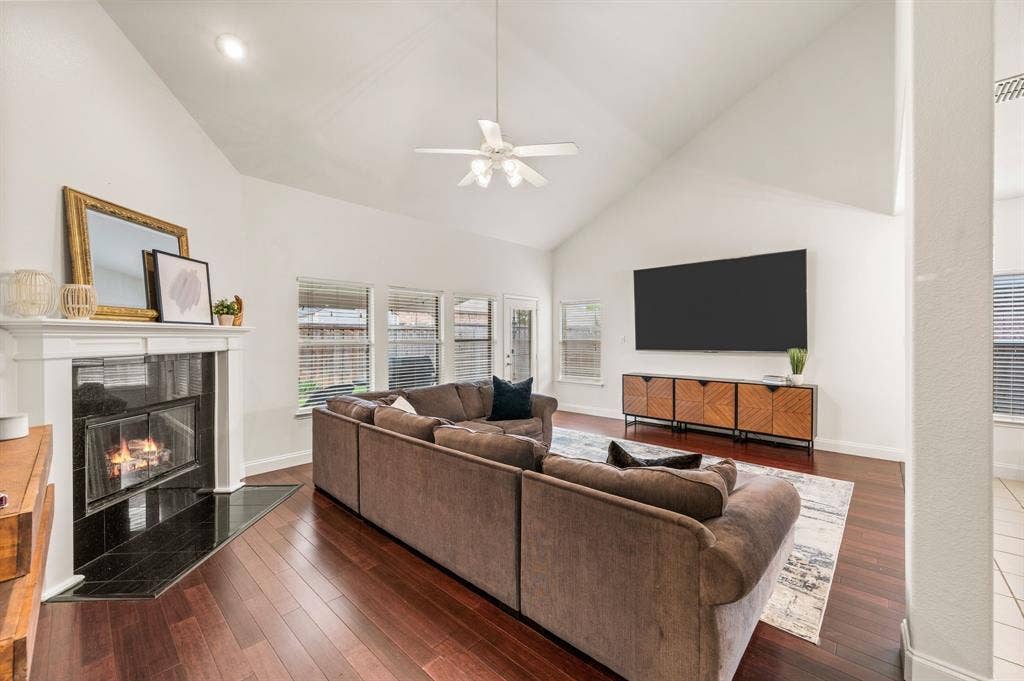 308 Bradbury Drive, Euless, TX 76040 Expansive living room with soaring vaulted ceilings, cozy fireplace & walls of windows!