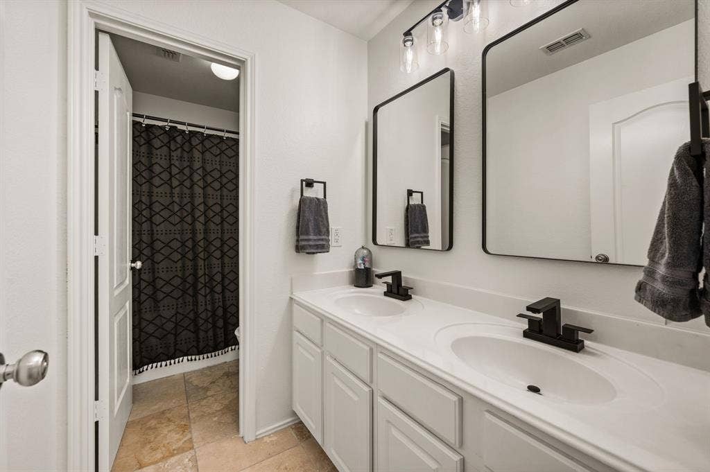 308 Bradbury Drive, Euless, TX 76040 Updated secondary bath with dual sinks, modern fixtures & clean contemporary style.