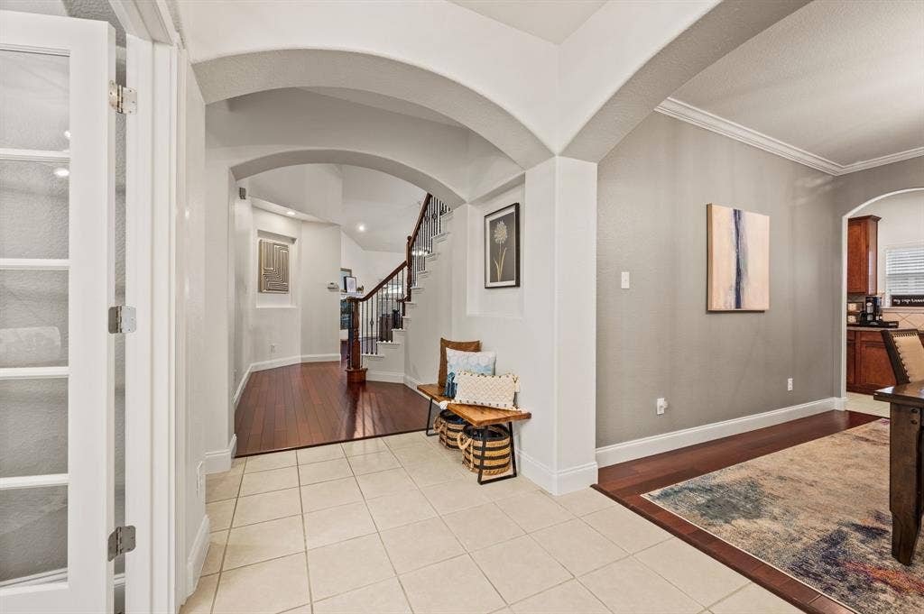 308 Bradbury Drive, Euless, TX 76040 Grand entryway with arched openings & an airy, open-concept flow throughout the home.