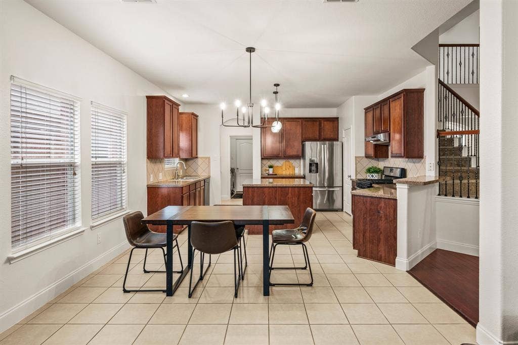308 Bradbury Drive, Euless, TX 76040 Spacious eat-in kitchen with oversized island, abundant cabinetry & stainless steel appliances.