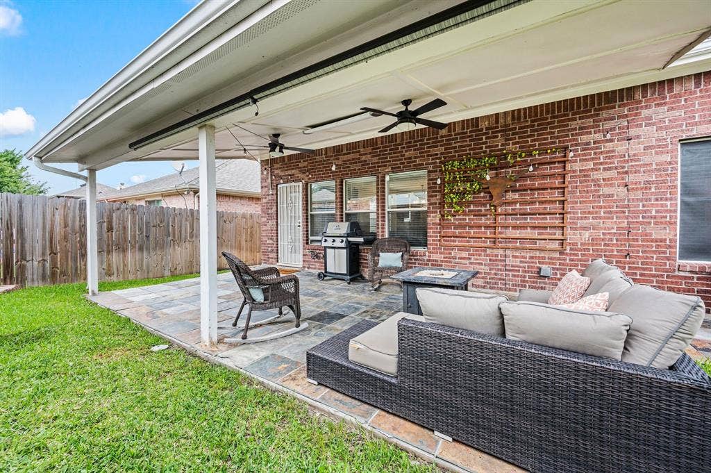 308 Bradbury Drive, Euless, TX 76040 Spacious covered outdoor retreat with grilling area, cozy seating & stylish tile flooring.