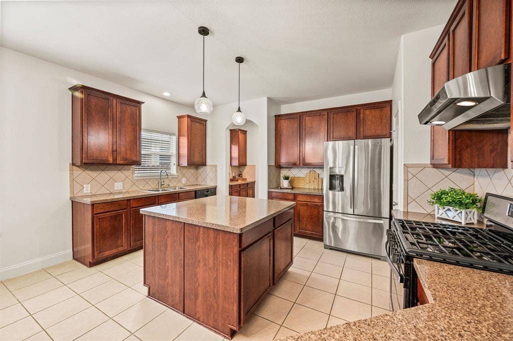 308 Bradbury Drive, Euless, TX 76040 Large center island anchors this beautifully designed kitchen with plenty of room to gather.