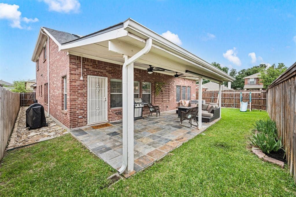 308 Bradbury Drive, Euless, TX 76040 Backyard oasis with covered entertaining space, lush lawn & plenty of room to play.