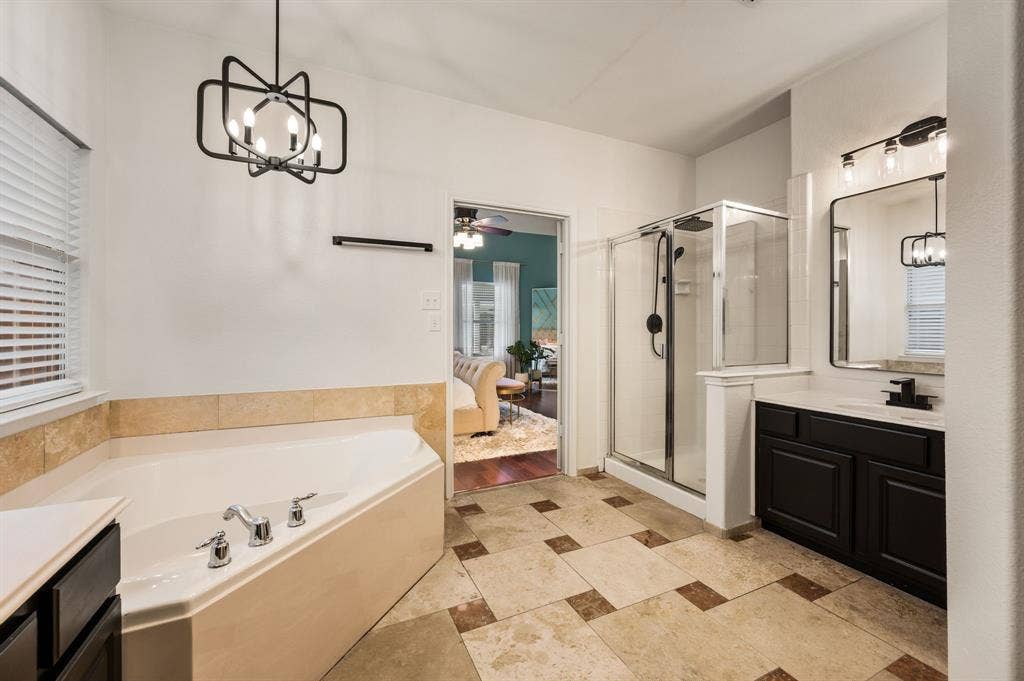 308 Bradbury Drive, Euless, TX 76040 Relaxing primary bath with soaking tub, modern fixtures & generous natural light.