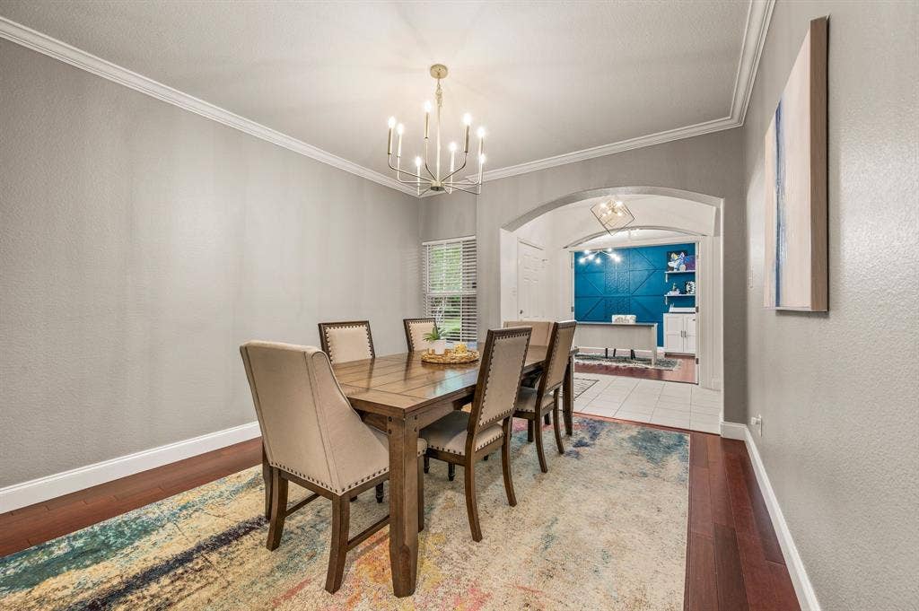 308 Bradbury Drive, Euless, TX 76040 Another view of the spacious dining area featuring warm hardwood floors & elegant architectural details.